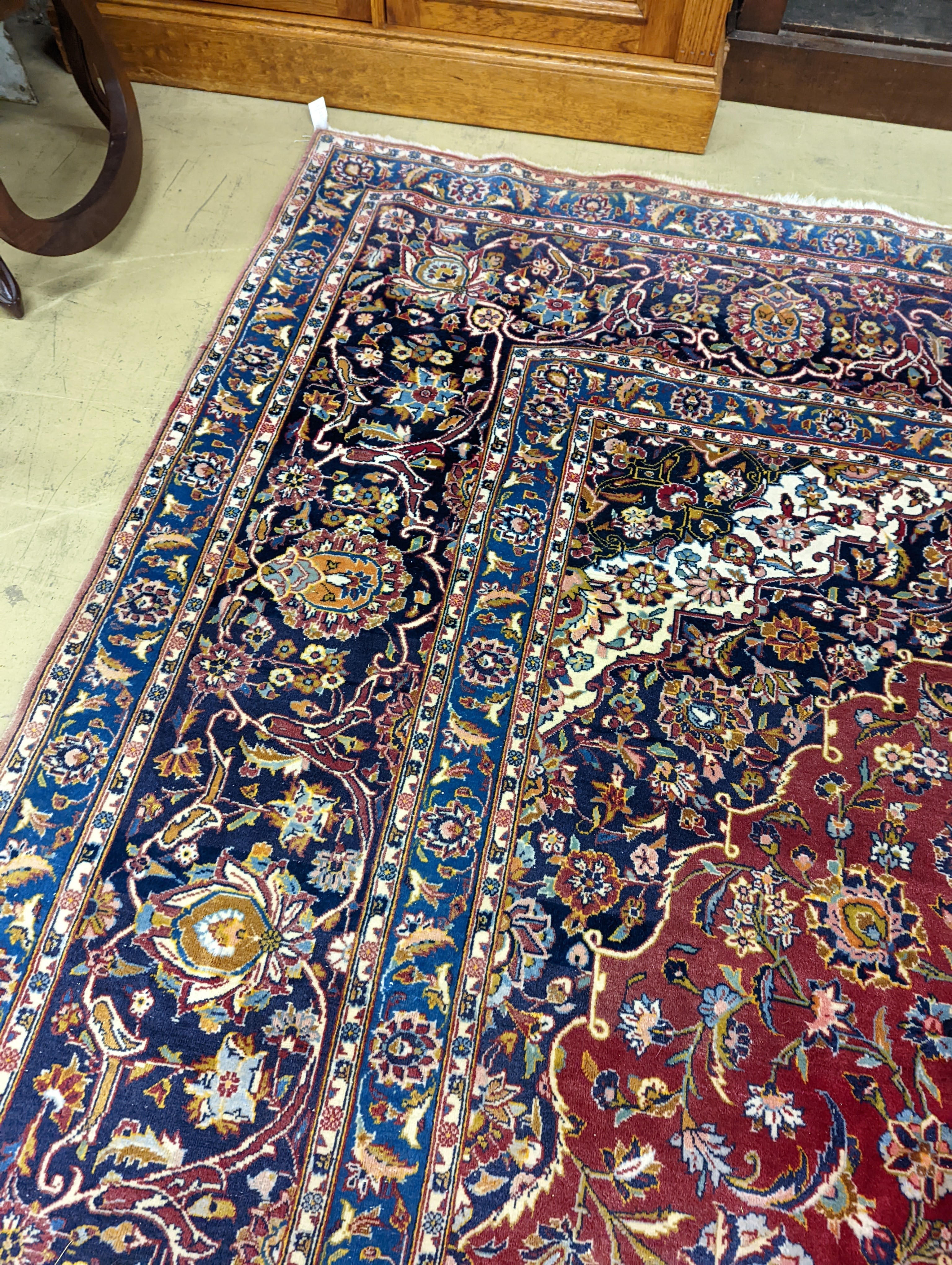 A large Tabriz red ground floral carpet, 540 x 350cm